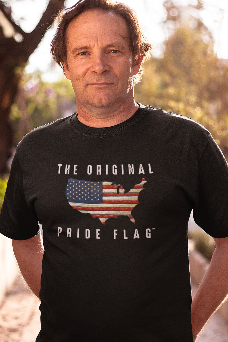 Older man wearing The Original Pride Flag unisex t-shirt