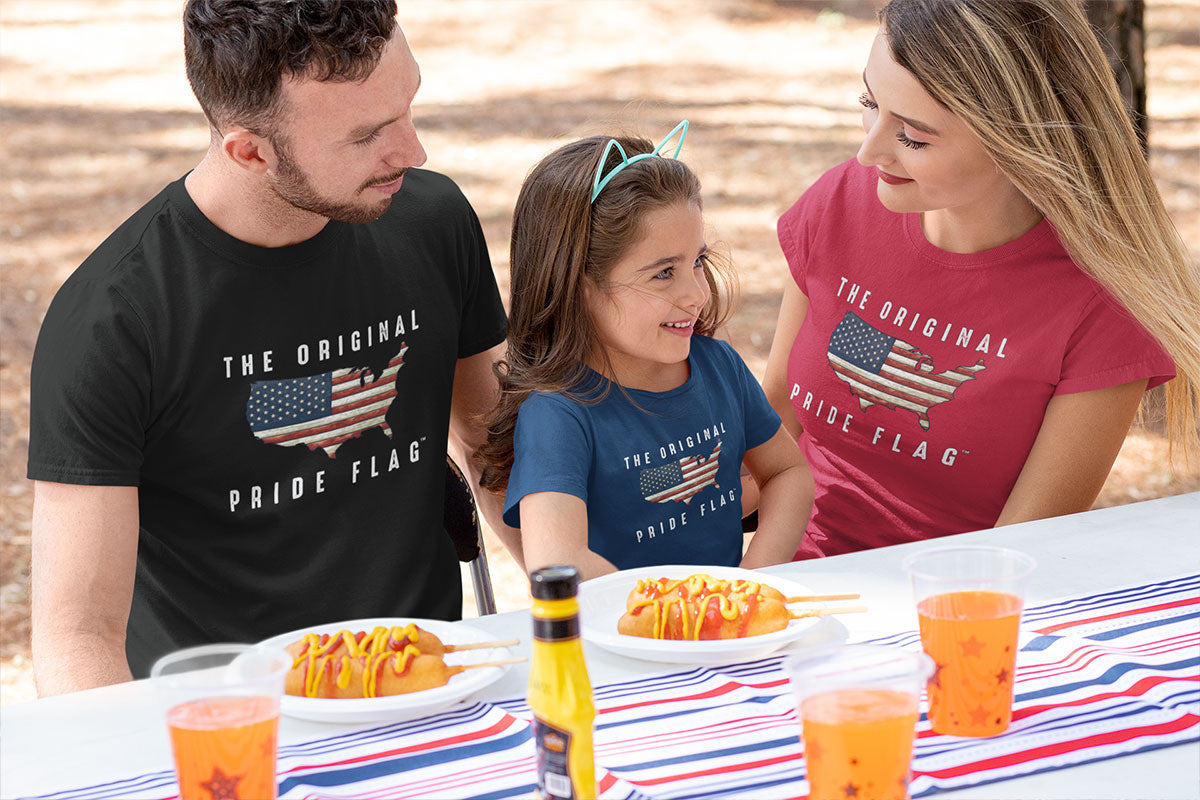 Family at picnic table wearing The Original Pride Flag t-shirts