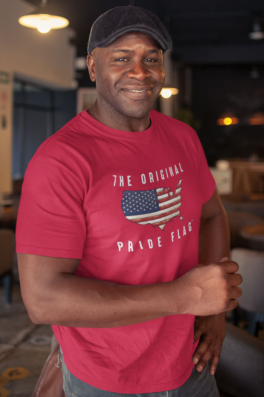Man wearing red The Original Pride Flag t-shirt